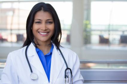 Closeup headshot portrait of smiling female, healthcare professional with lab coat