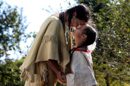  A Native American Indian Lakota Sioux mother looking into the eyes of her daughter