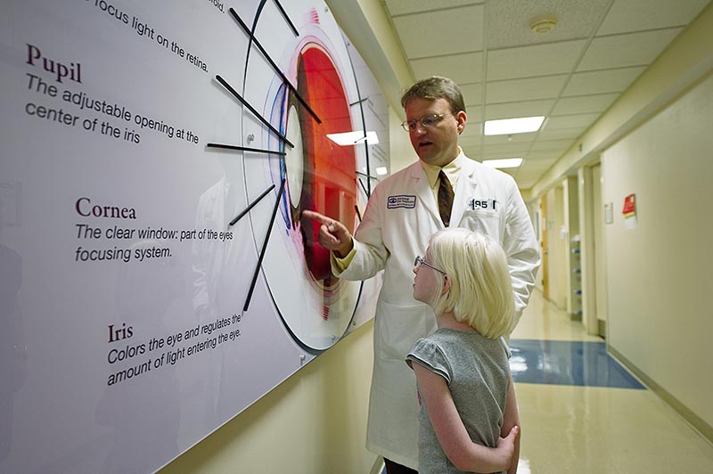 Dr. Brooks explains parts of the eye to Lotus