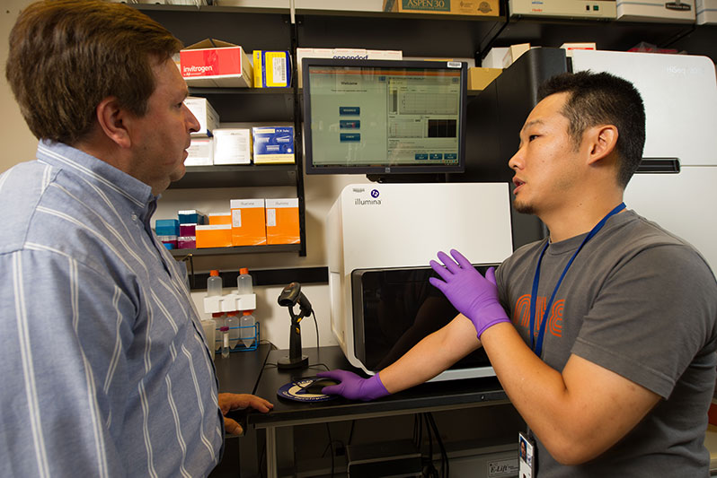 Research assistant Gustavo Gutierrez, Ph.D., and visiting fellow Arito Yamane, M.D., Ph.D., use high-throughput sequencing to gather data from experiments at the bench