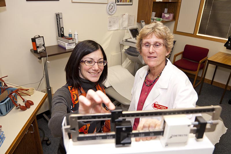 Fox and Clinic Manager Emily Manders prepare a patient examination room