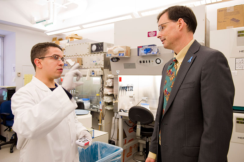 Postdoctoral fellow Joseph Raymond Cohen, Ph.D. (left), and James Gulley, M.D., Ph.D., confer on laboratory findings