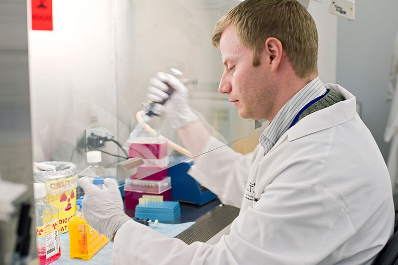 Postdoctoral fellow Duane Hamilton, Ph.D., prepares cells for study