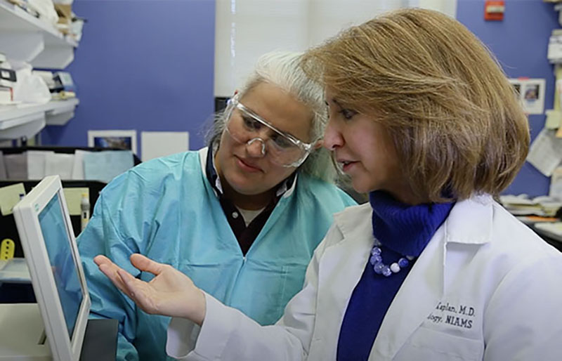 Dr. Kaplan discusses laboratory results with staff scientist Luz Blanco