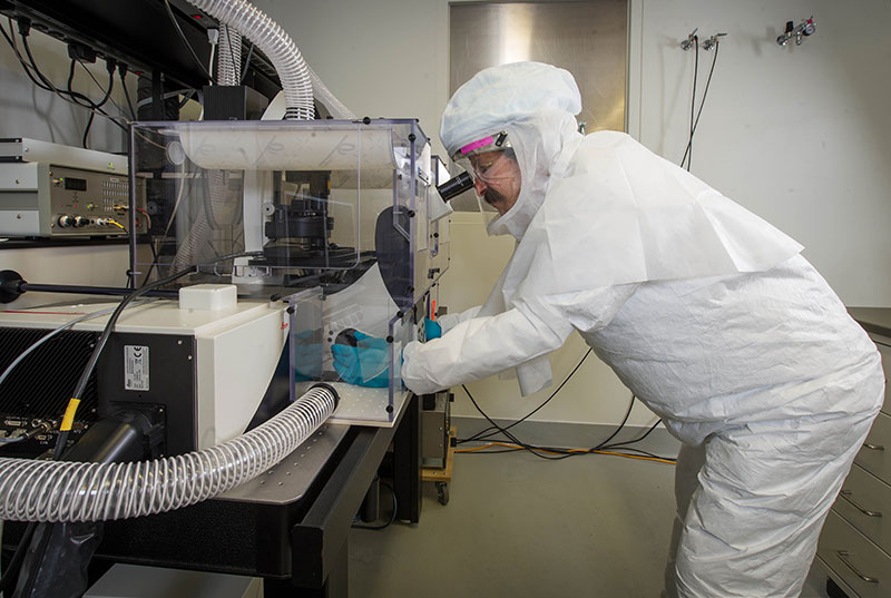Dr. Schwartz examining a mouse lung infected with tuberculosis in the BSL-3 laboratory