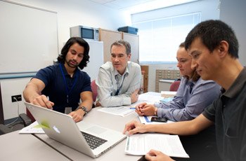 Team members (l to r) Arjun Sanghvi, Kevin Hall, Stephanie Goodwin, and Juen Guo review progress on new metabolic models