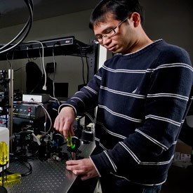 Research fellow Yicong Wu, Ph.D., adjusts a SPIM microscope